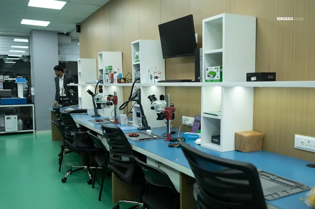 Row of repair workbenches with microscopes and soldering stations at iPhone Fixer Nashik