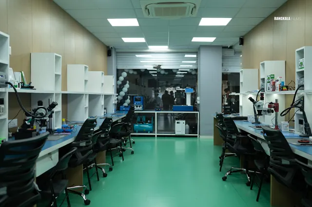 The Nashik repair workshop: two rows of microscope workbenches on a green floor